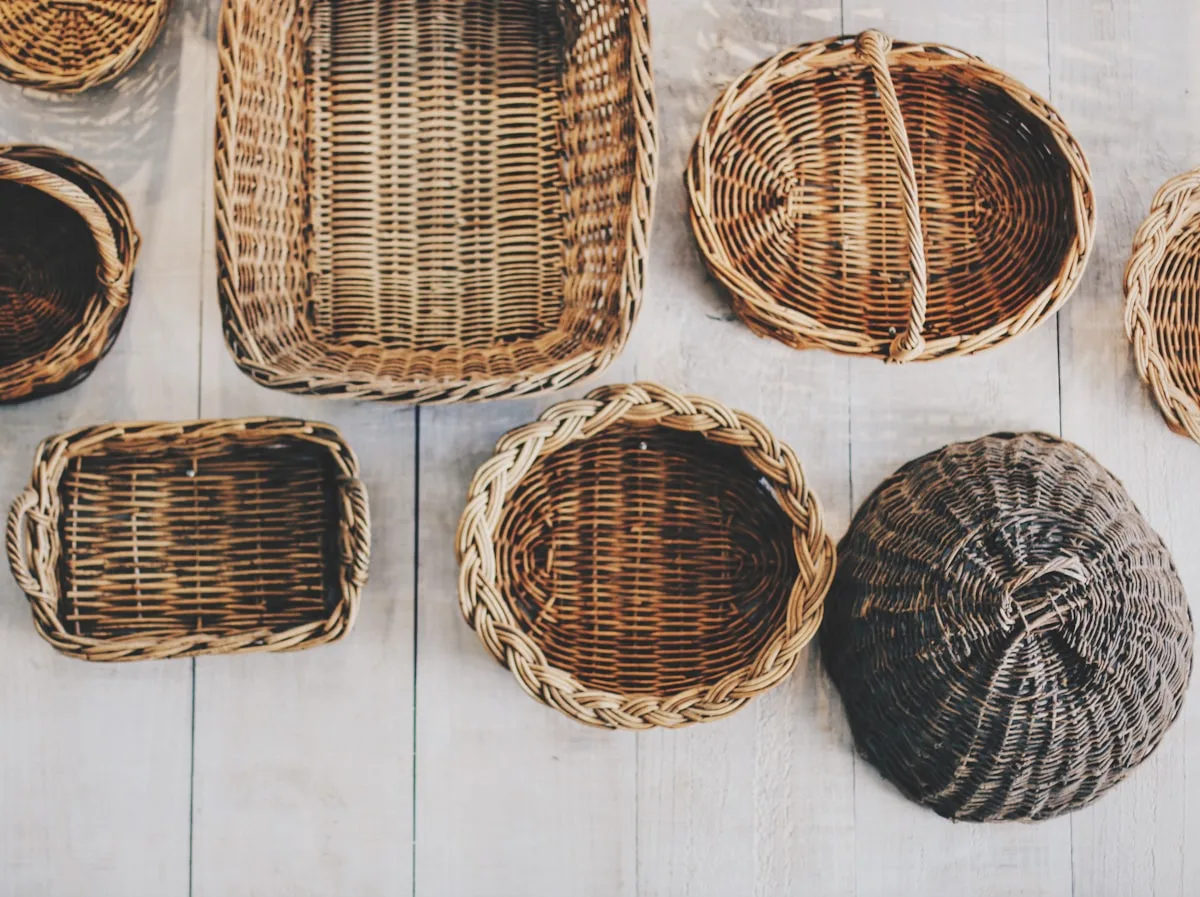 Assorted handwoven baskets arranged on a white wood surface