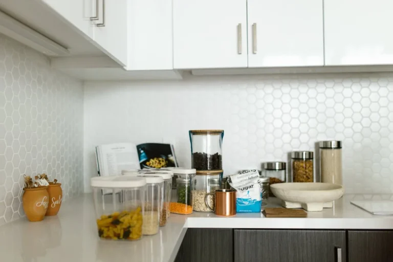 White hexagon tile backsplash in a bright modern kitchen