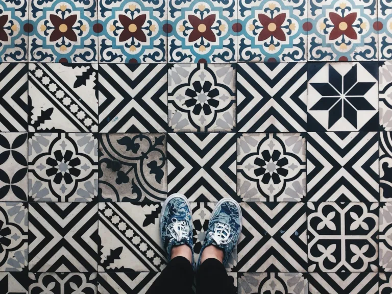 Renter bathroom floor with encaustic patterned peel-and-stick floor tile in black and white