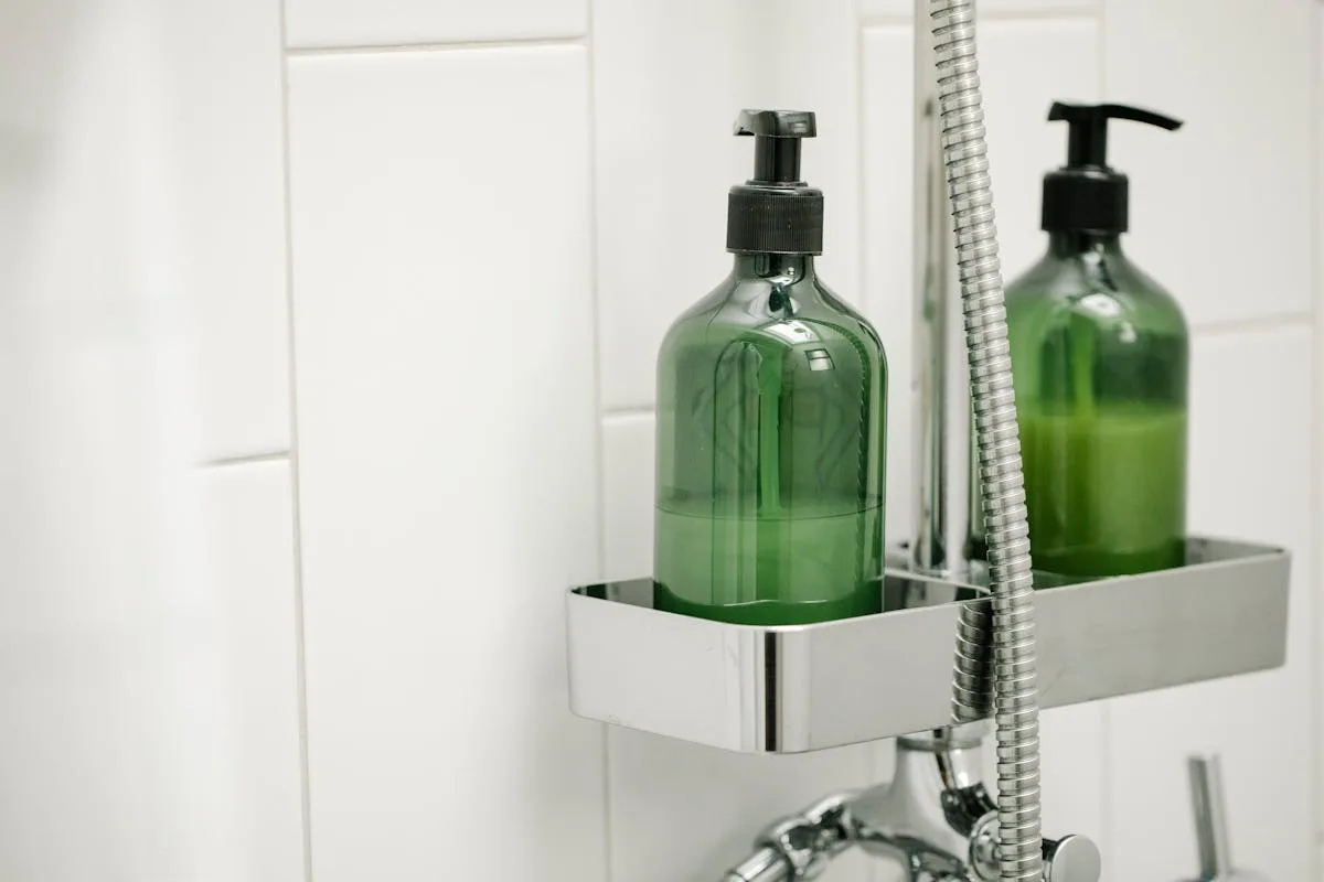 Shower caddy holding bottles on a tiled bathroom wall