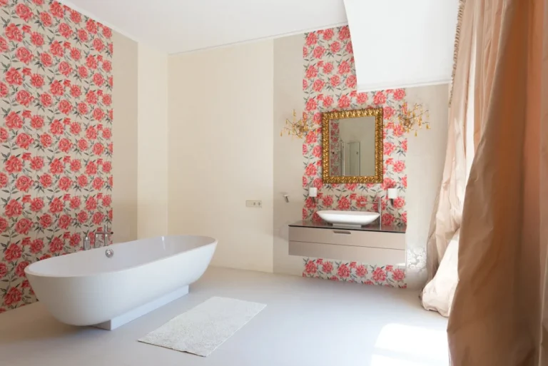 White bathroom with a delicate botanical wallpaper and arched walk-in shower