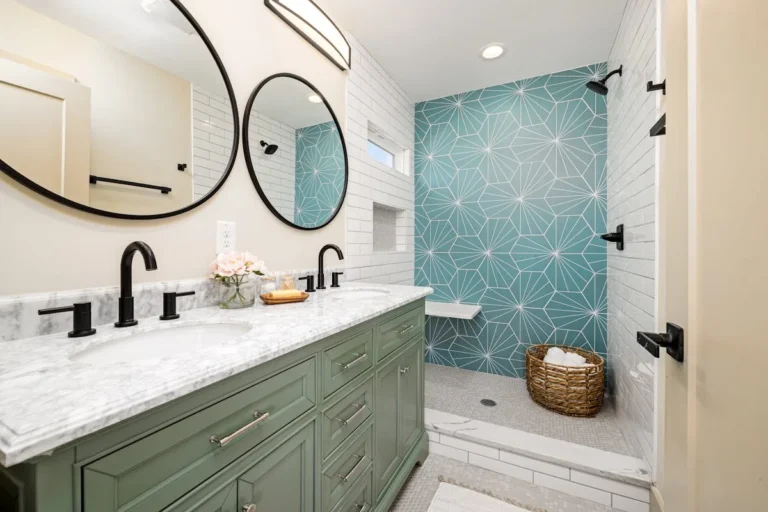 Bathroom with a bold teal geometric pattern wallpaper and green vanity