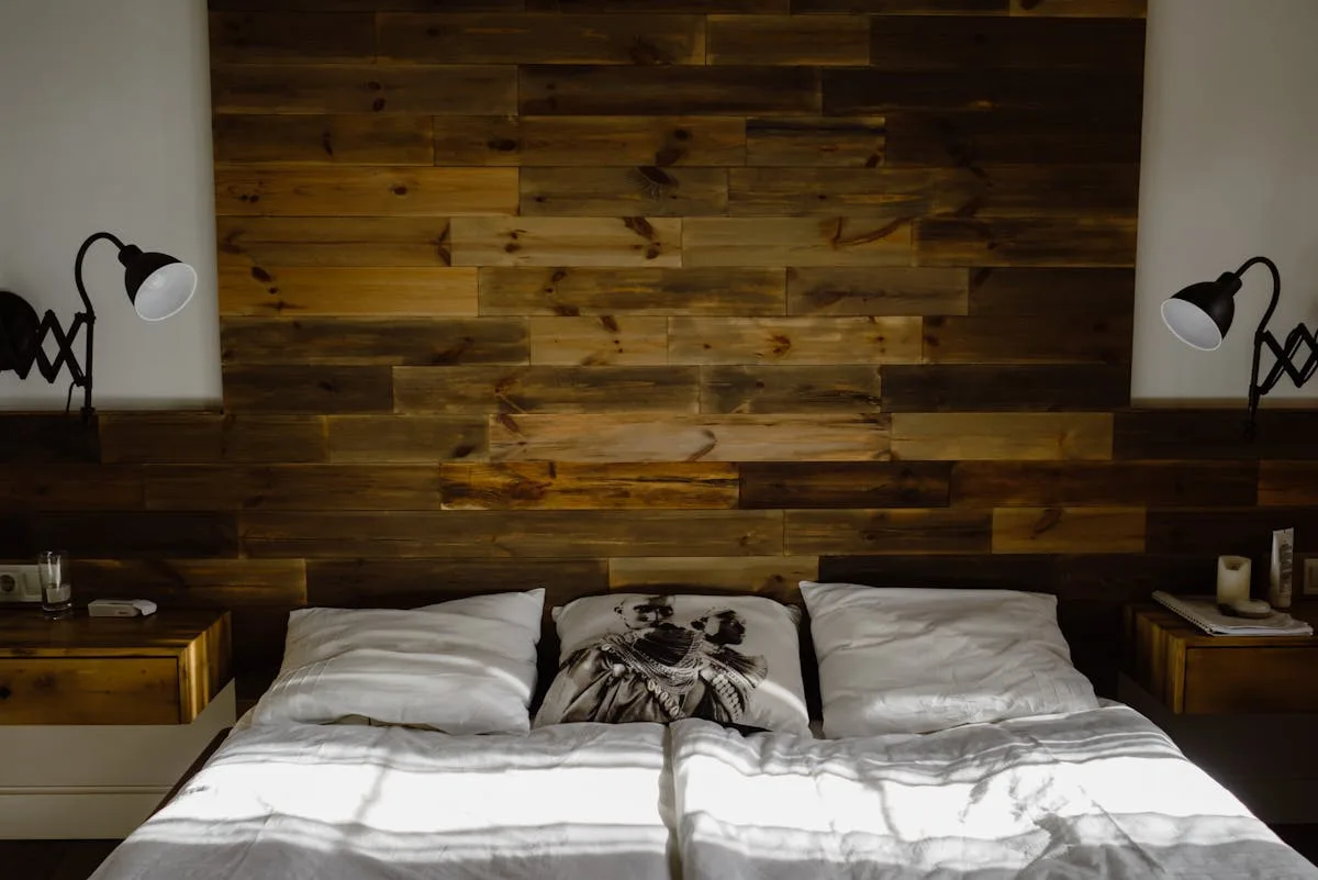 Renter bedroom with peel-and-stick reclaimed wood plank panel wall behind the bed acting as a custom headboard