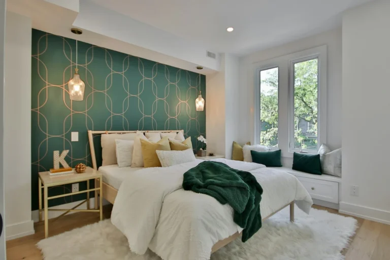Bedroom with a green geometric peel-and-stick wallpaper accent wall behind the bed