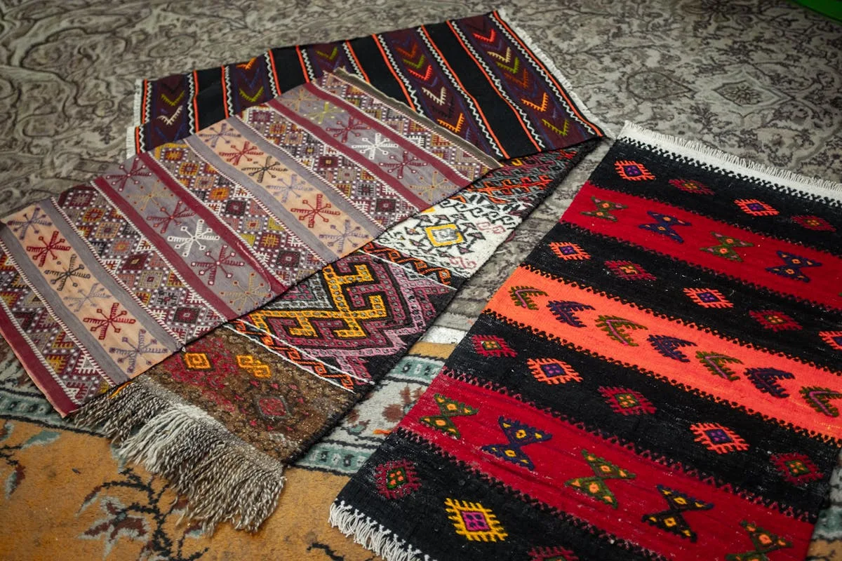 Patterned kilim rug layered over a larger rug on the floor