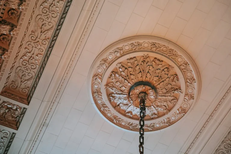 Ornate ceiling medallion around a hanging fixture chain