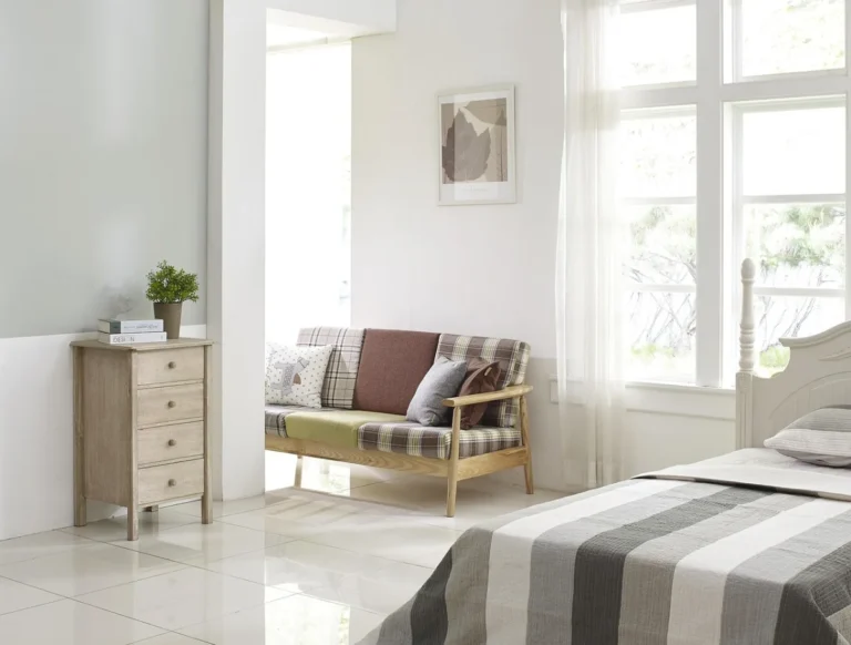 White slipcovered sofa in a bright neutral living room