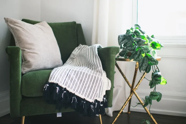 Cream crochet throw blanket draped over a chair