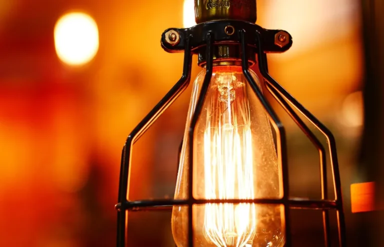 Warm white bulb glowing in a cozy apartment lamp