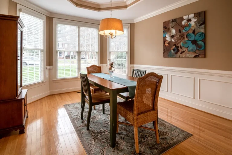 Dining room with crown molding bay window and chandelier