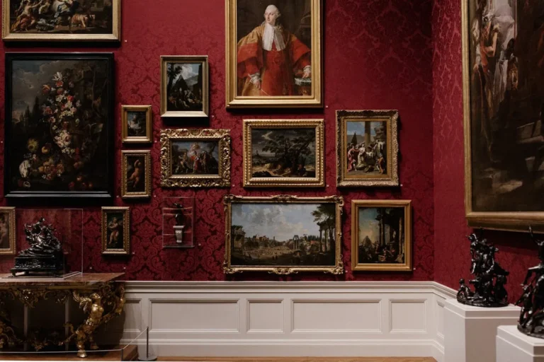 Gold-framed classical art hung on a moody wall