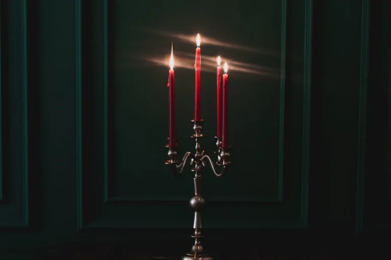 Taper candles in brass holders casting a warm glow