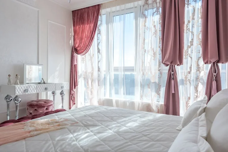 Deep velvet curtains framing a window in a dark academia room