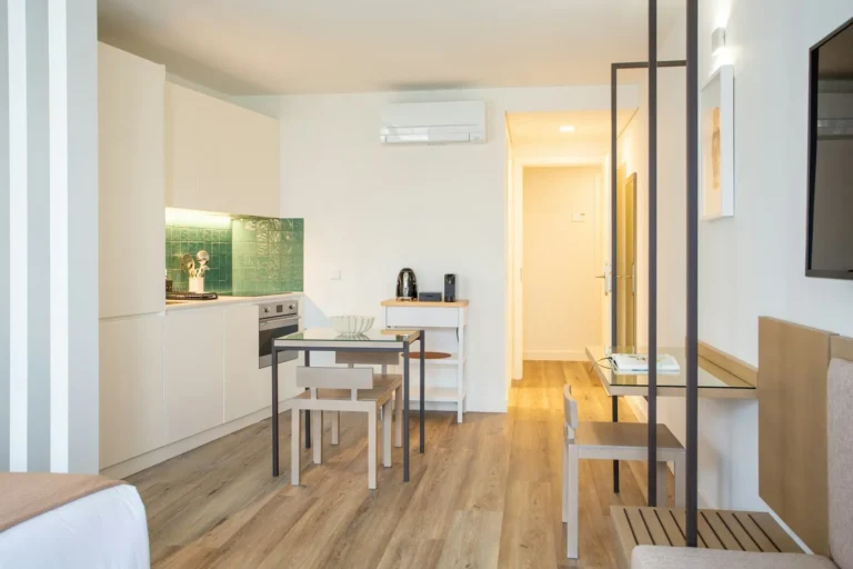 Small first apartment kitchenette with white cabinets and a tiled backsplash