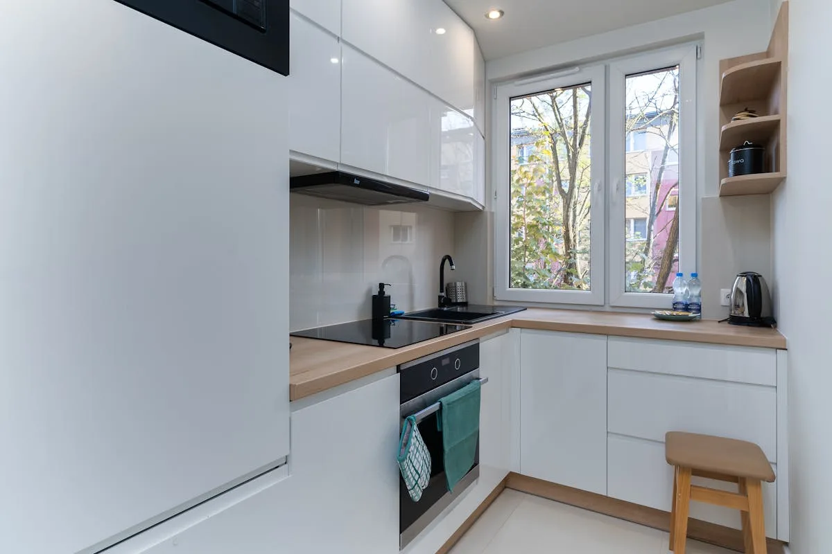 Small apartment kitchen with essential cookware and a bright window