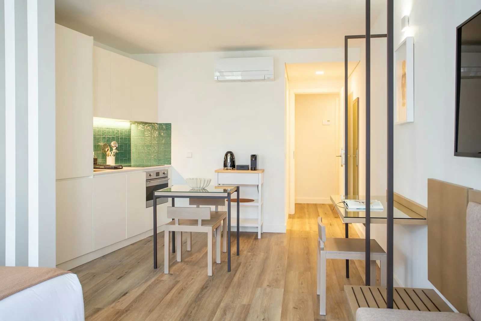 Small first apartment kitchenette with white cabinets and a tiled backsplash