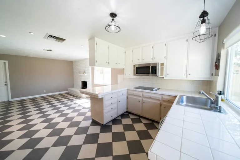 Black and white checkered floor tile in a bright open kitchen