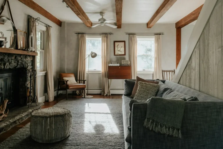 Cozy small living room with a woven storage ottoman and a sofa in warm neutral tones