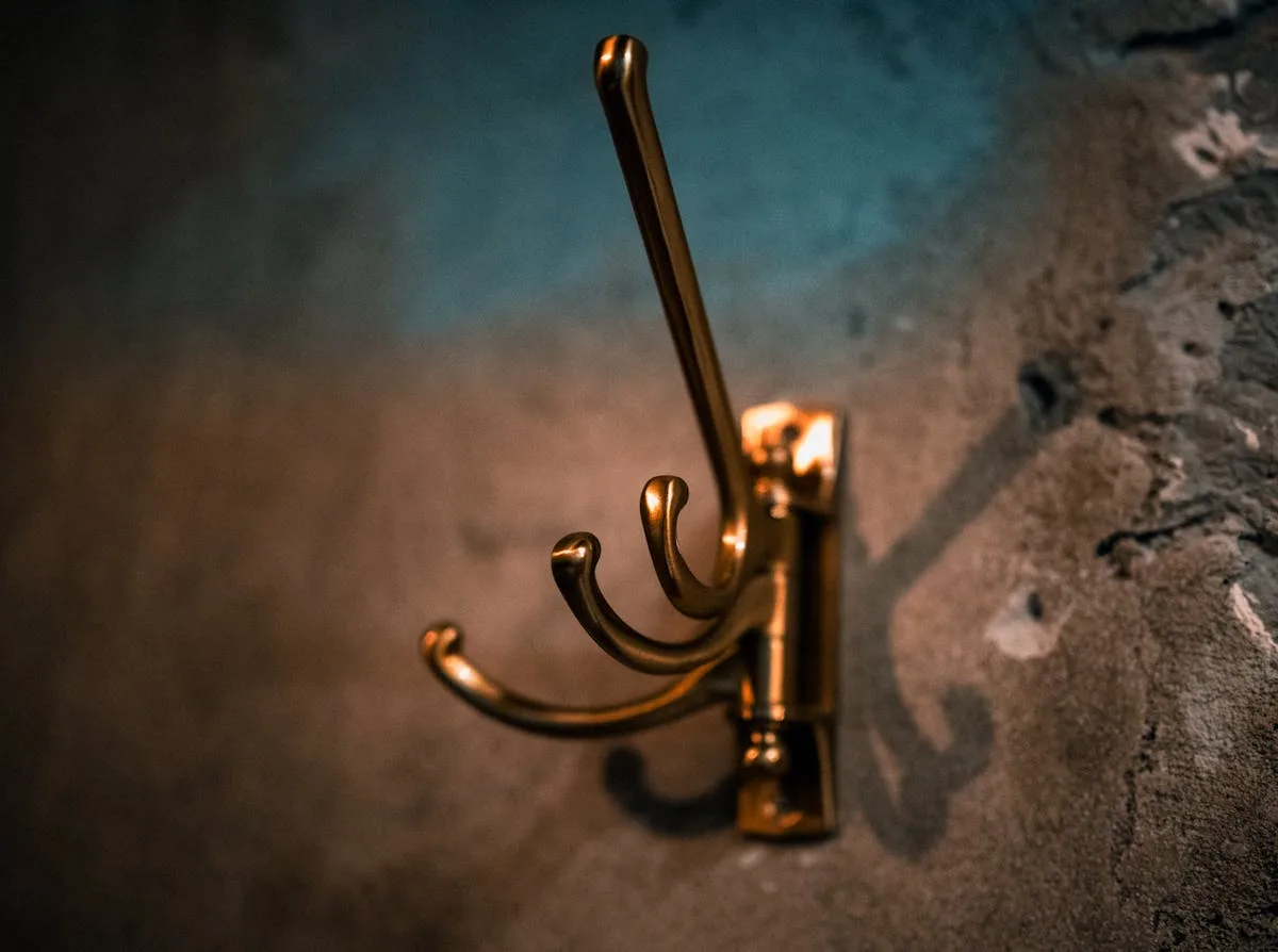 Adhesive command-style hooks mounted on a clean white wall