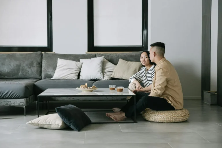 Calm japandi living room with a low sofa, floor cushions, and natural materials