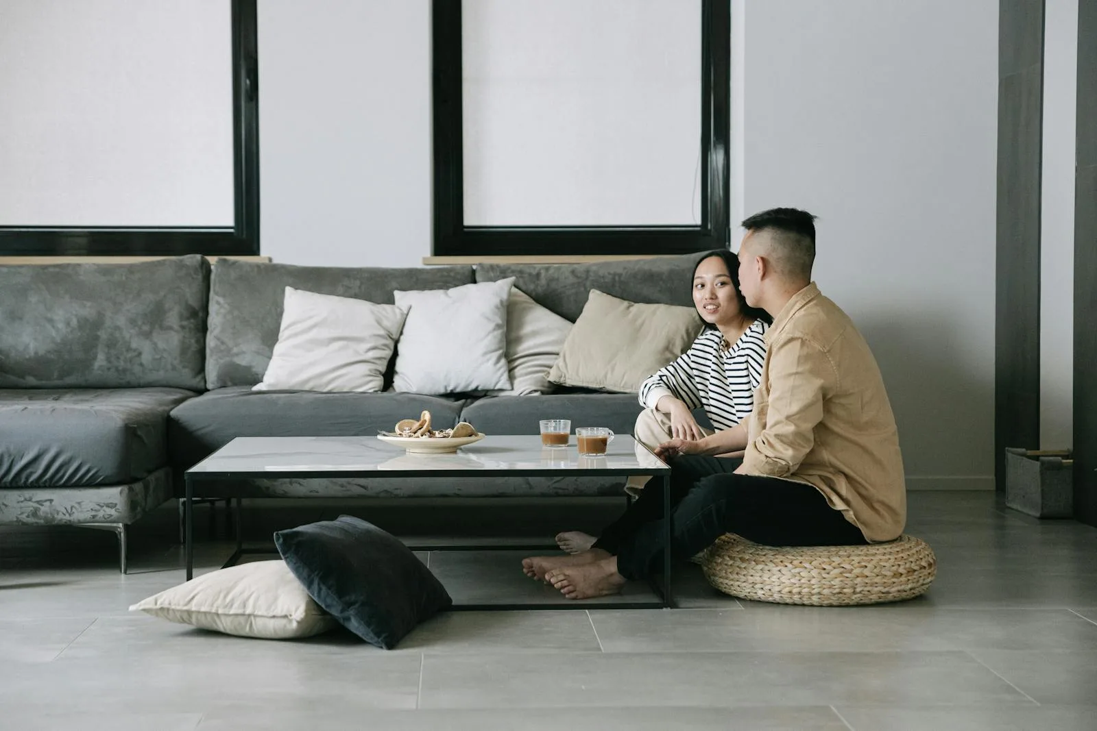Calm japandi living room with a low sofa, floor cushions, and natural materials
