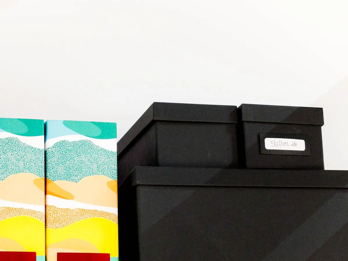 Labeled storage boxes and magazine files arranged on a shelf