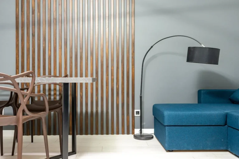 Arc floor lamp curving over a sofa in a small living room