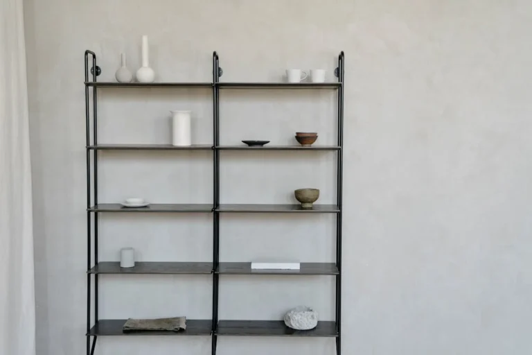 Slim tall bookcase holding books against an apartment wall