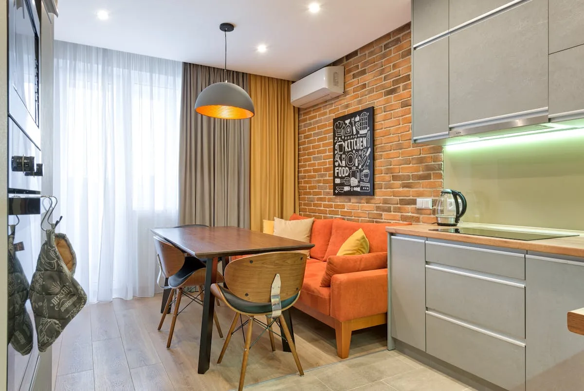 Small apartment living and dining area with a sofa and a compact table