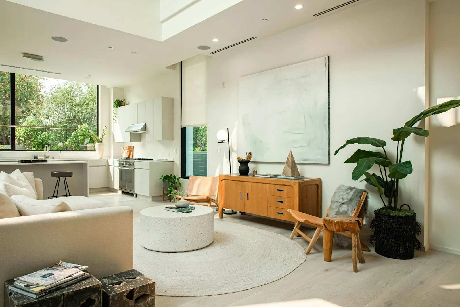 Bright mid-century modern living room with a walnut credenza and wood accent chair