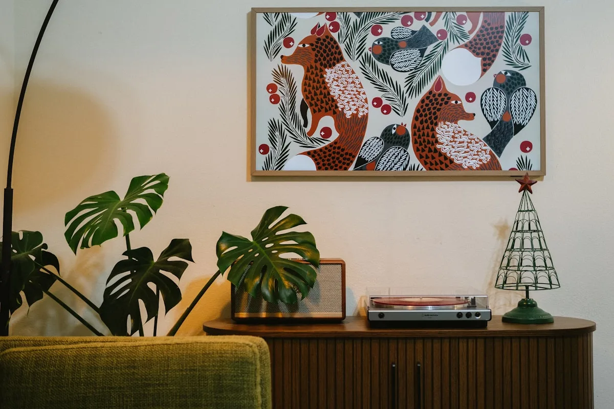 Walnut mid-century sideboard with a record player, arc lamp and framed art