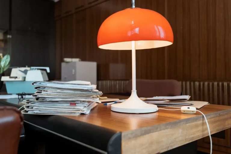 Mid-century mushroom table lamp glowing warm on a side table