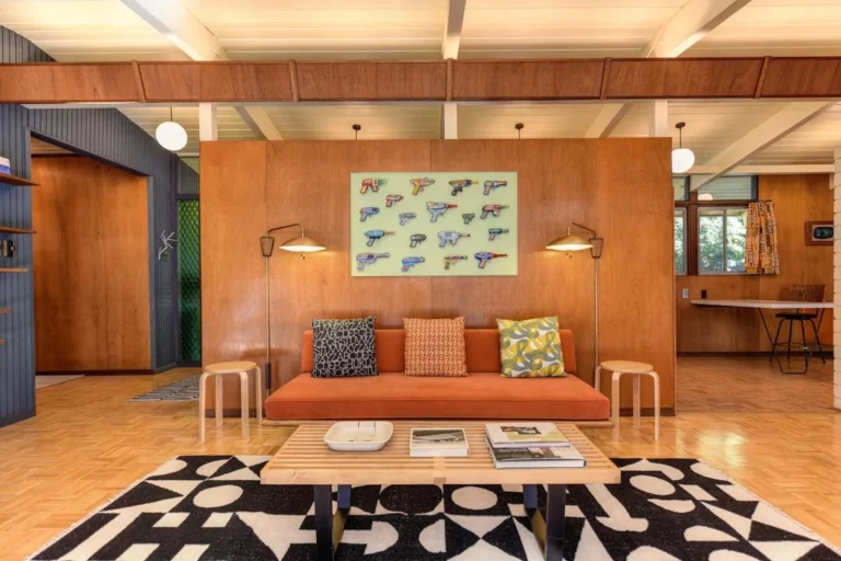 Mid-century patterned throw pillows on a small sofa