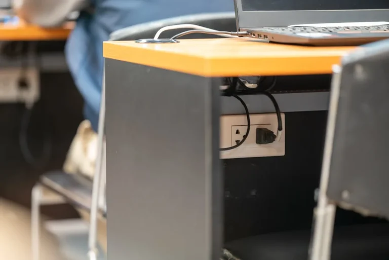 Cable management box hiding cords under a tidy desk