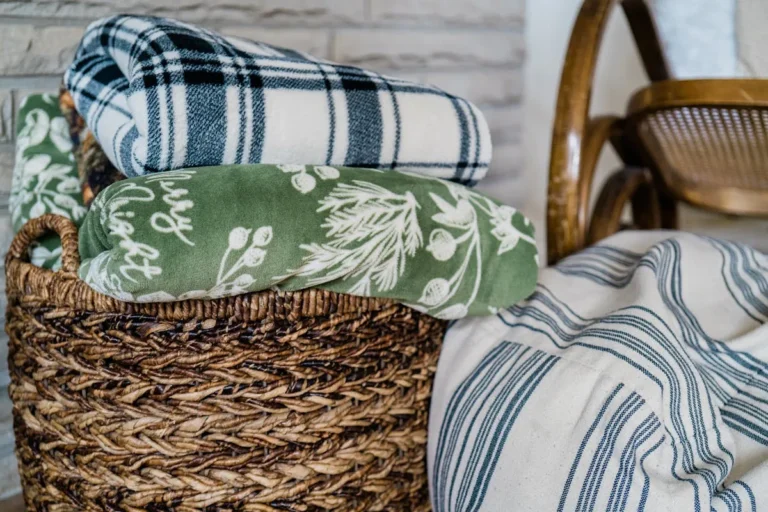 Large seagrass basket holding a throw in a minimalist room