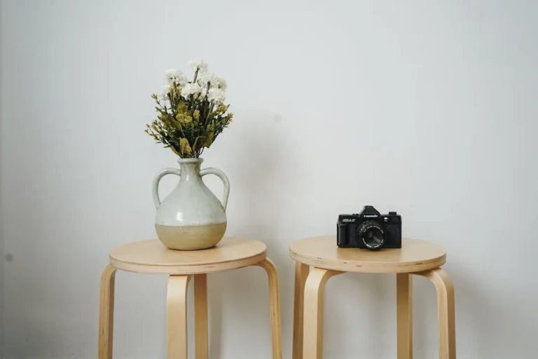 Small round wood stool in a minimalist corner