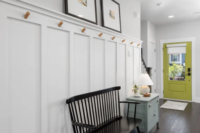 Hook rack on a door holding coats