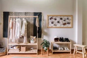 Renter entryway with a hanging clothes rack and shoe bench storage