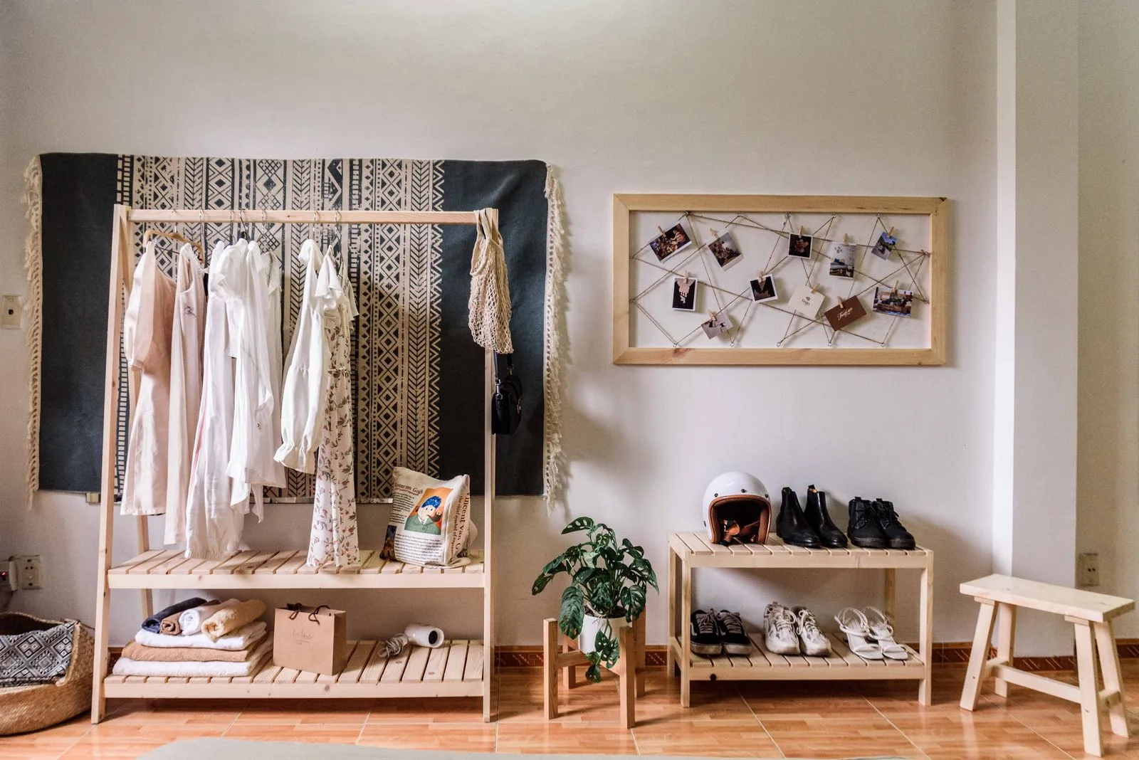 Renter entryway with a hanging clothes rack and shoe bench storage