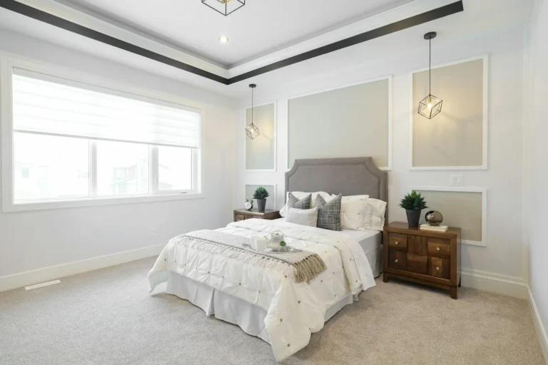 Bright bedroom with a deep tray ceiling and decorative molding details around the perimeter