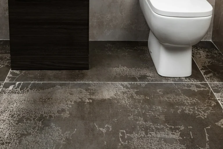 Small rental bathroom with patterned floor tile in muted blue and cream, white subway shower walls