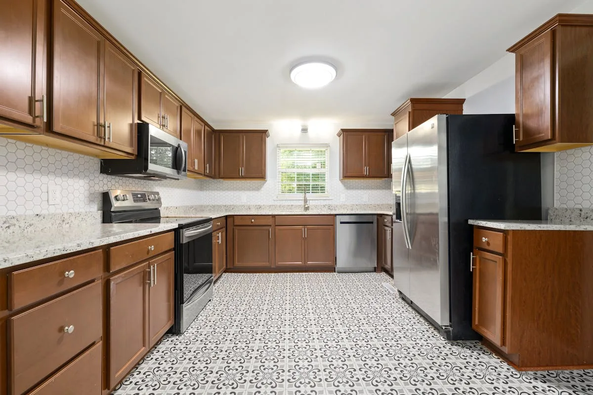 Renter-friendly peel-and-stick vinyl floor tile in a small rental kitchen