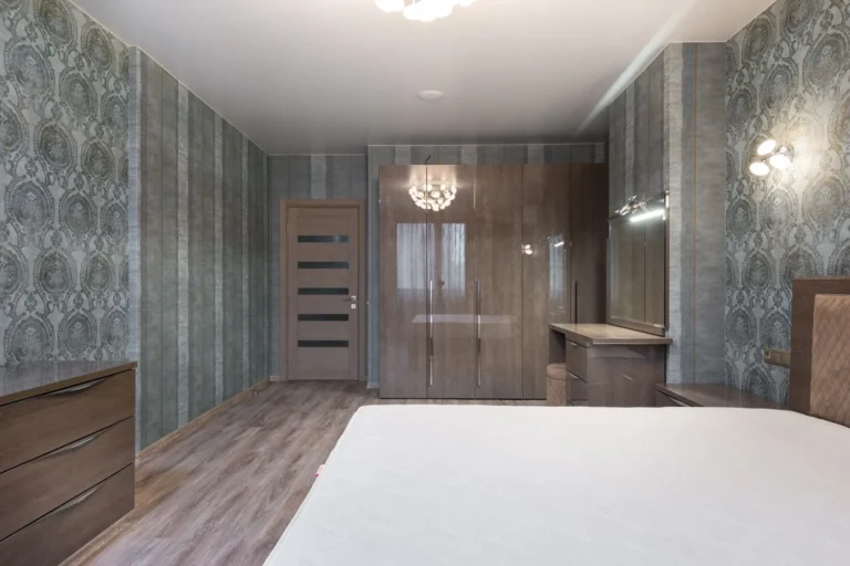 Bedroom with patterned peel-and-stick wallpaper installed on multiple walls