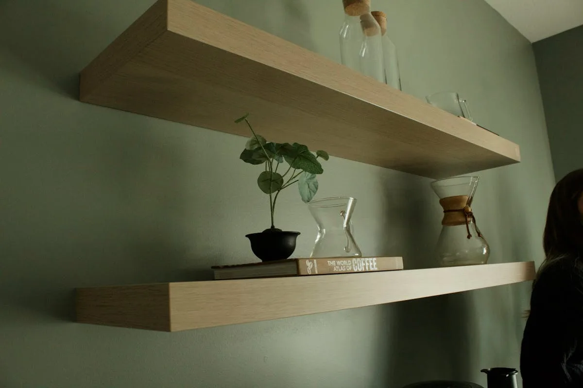 Small floating shelf with potted plants in a bright bedroom corner