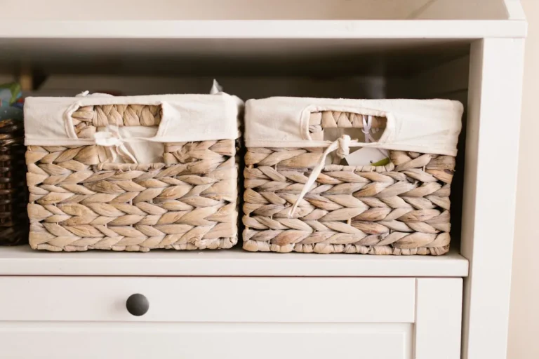 Fabric cube storage bins lined up on an open shelf