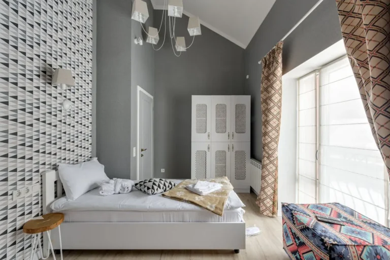 Bedroom with bold geometric peel-and-stick accent wall behind the bed in budget-friendly graphic pattern