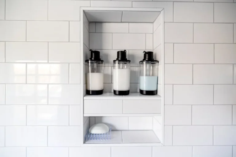 Shower shelf holding shampoo bottles