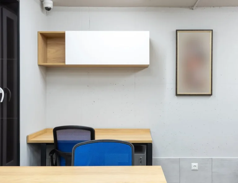 Wall-mounted fold-down desk in a compact apartment corner