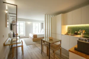 Bright studio apartment with a bed, kitchenette and open living area divided into zones