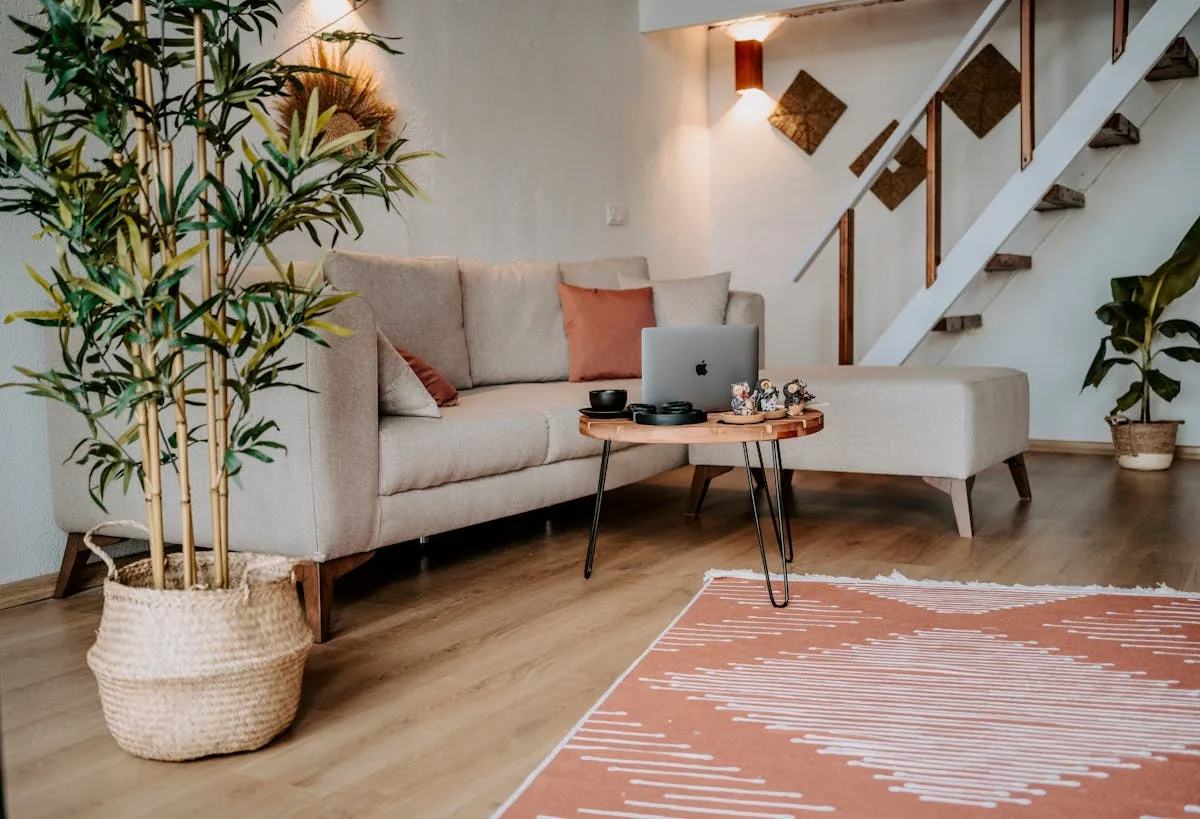 Cozy small living room with a beige sofa, an ottoman bench, and a warm rug